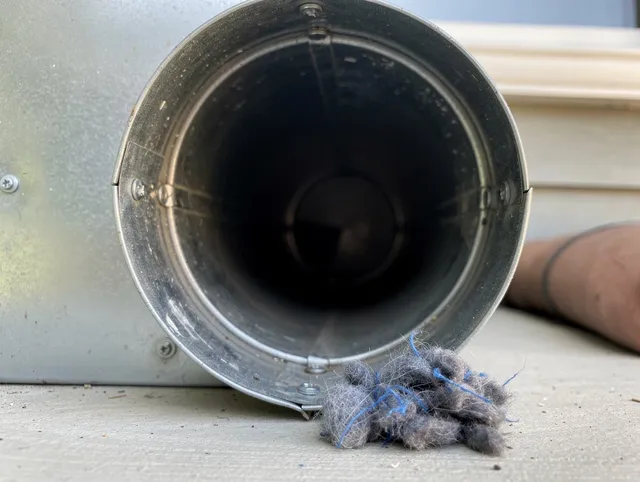 Worthington Dryer Vent Cleaning technician using specialized equipment to clear severe dryer vent blockage in Worthington